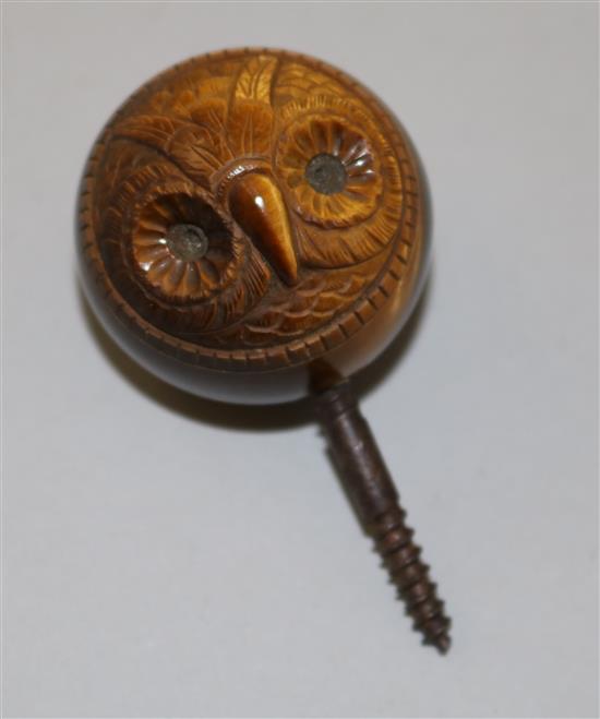 An early 20th century tigers eye quartz cane handle carved with the face of an owl, diameter 1.75in.